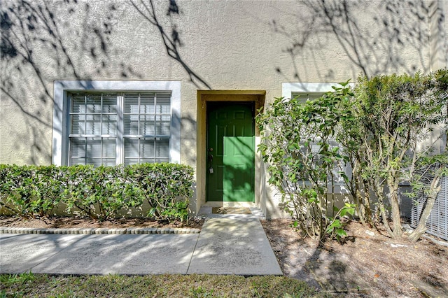 entrance to property with stucco siding