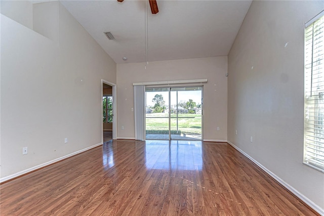 spare room featuring a ceiling fan, wood finished floors, visible vents, and baseboards