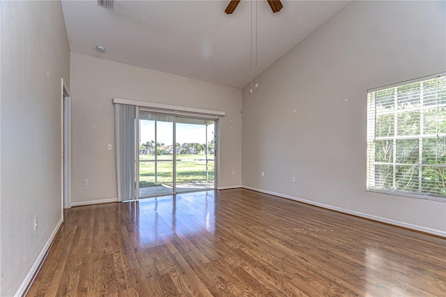 unfurnished room featuring high vaulted ceiling, baseboards, ceiling fan, and wood finished floors