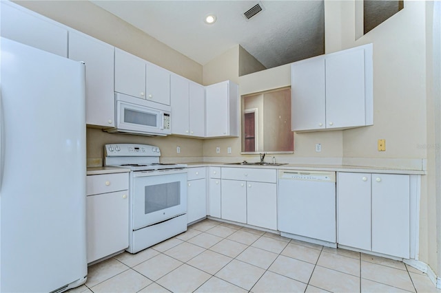 kitchen featuring white appliances, light countertops, visible vents, and a sink