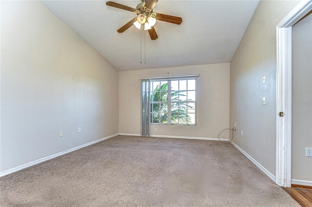 unfurnished room featuring baseboards, a ceiling fan, and vaulted ceiling