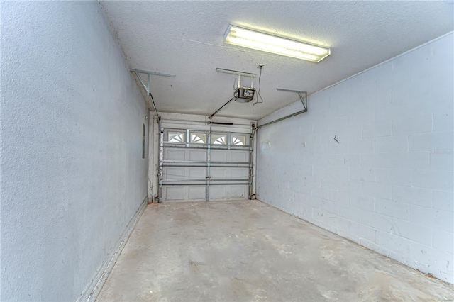 garage with concrete block wall and a garage door opener