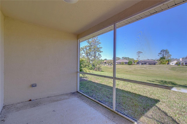 unfurnished sunroom with a residential view