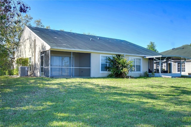 back of property featuring cooling unit, a yard, a sunroom, and stucco siding