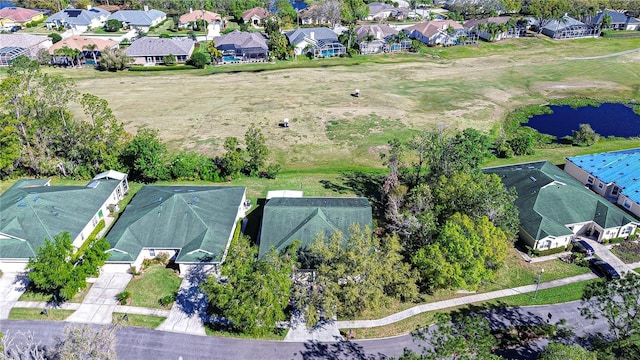 drone / aerial view featuring a residential view and a water view