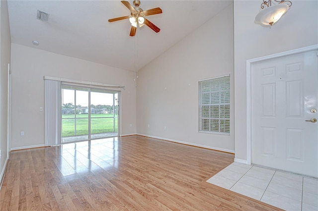 34907 Double Eagle Ct, Zephyrhills, FL 33541 - entrance foyer with high vaulted ceiling, a ceiling fan, light wood-type flooring, and baseboards
