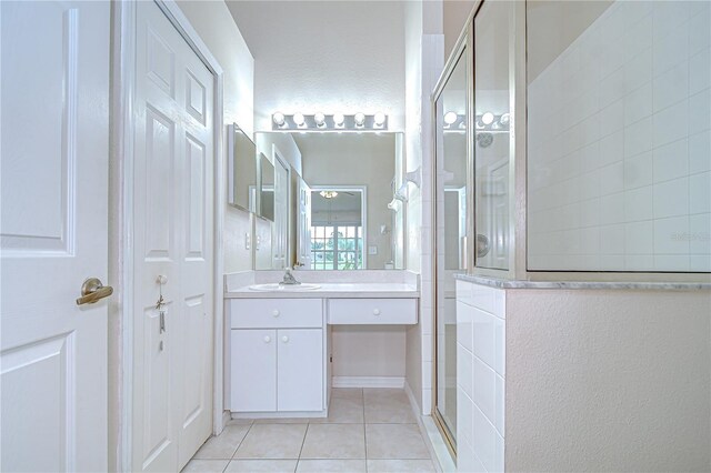 34907 Double Eagle Ct, Zephyrhills, FL 33541 - bathroom featuring a walk in shower, vanity, and tile patterned flooring