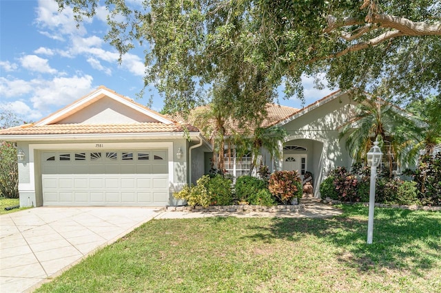 7581 Palmer Glen Cir, Sarasota, FL 34240 - view of front facade with a tile roof, stucco siding, and a garage