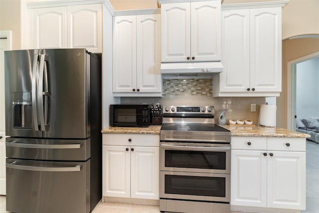 7581 Palmer Glen Cir, Sarasota, FL 34240 - kitchen featuring stainless steel appliances, under cabinet range hood, backsplash, white cabinets, and light stone countertops
