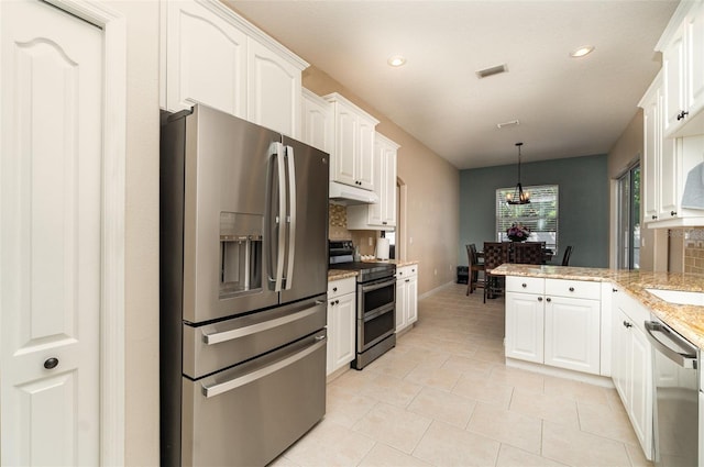 7581 Palmer Glen Cir, Sarasota, FL 34240 - kitchen with appliances with stainless steel finishes, tasteful backsplash, under cabinet range hood, white cabinetry, and recessed lighting