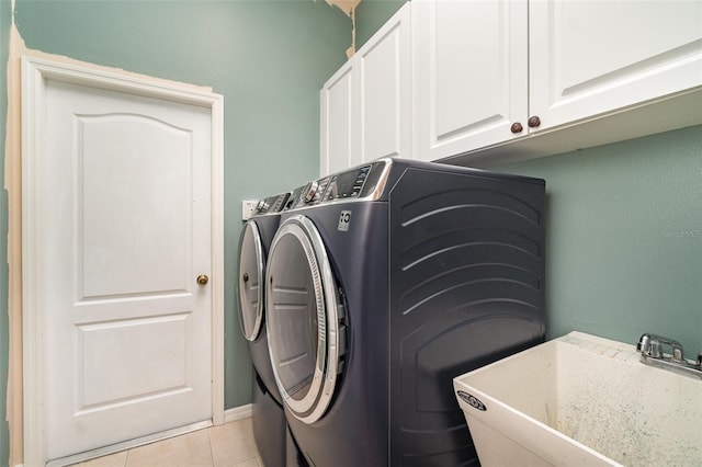 7581 Palmer Glen Cir, Sarasota, FL 34240 - laundry area featuring cabinet space, independent washer and dryer, light tile patterned floors, and baseboards