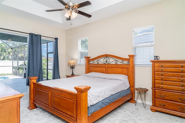 7581 Palmer Glen Cir, Sarasota, FL 34240 - bedroom featuring light colored carpet, access to exterior, a ceiling fan, and baseboards