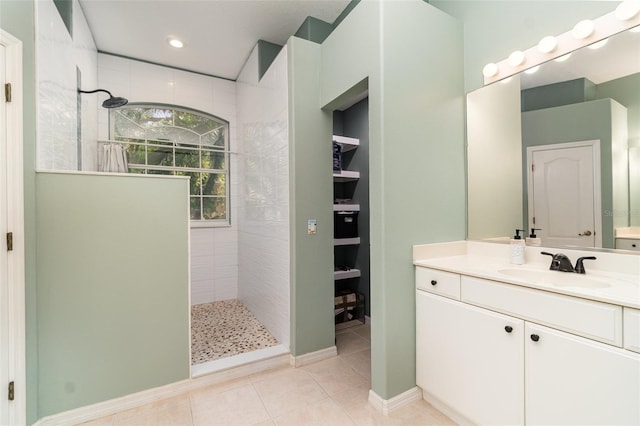 7581 Palmer Glen Cir, Sarasota, FL 34240 - bathroom with a walk in shower, tile patterned floors, vanity, and recessed lighting