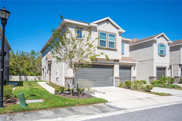 view of front of home with stone siding, stucco siding, an attached garage, and driveway