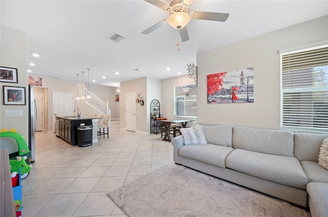 living room with a wealth of natural light, visible vents, a ceiling fan, recessed lighting, and light tile patterned flooring