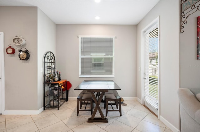 dining space with light tile patterned flooring and baseboards