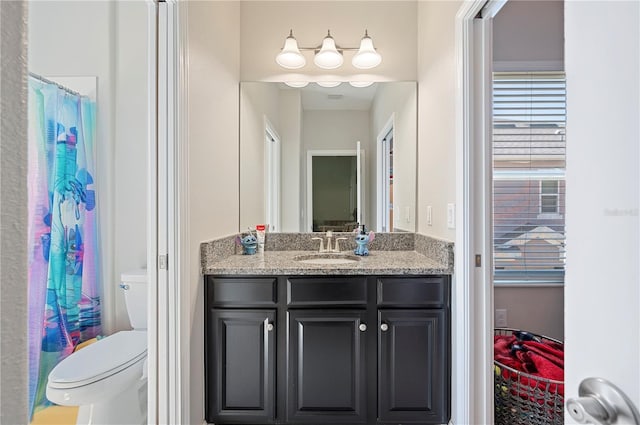 bathroom featuring vanity and toilet