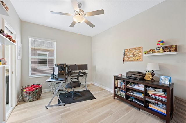 office area featuring baseboards, a ceiling fan, and wood finished floors