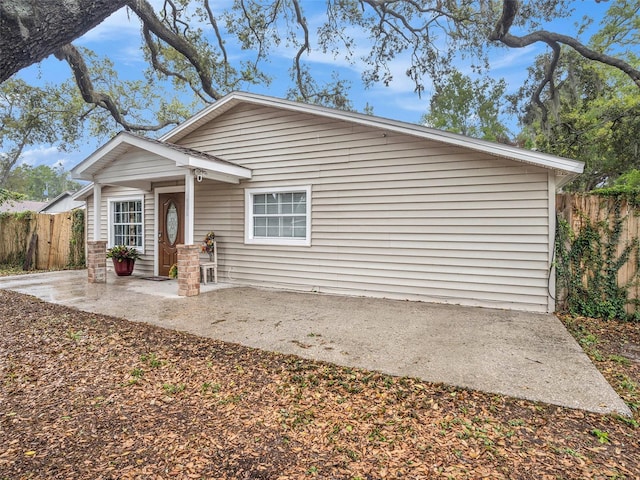 view of front of property with a patio and fence