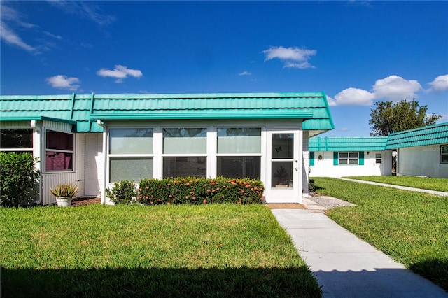 rear view of property featuring a yard