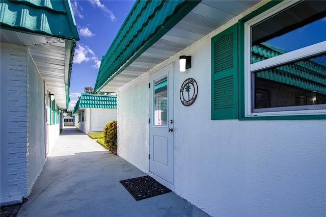 entrance to property featuring stucco siding