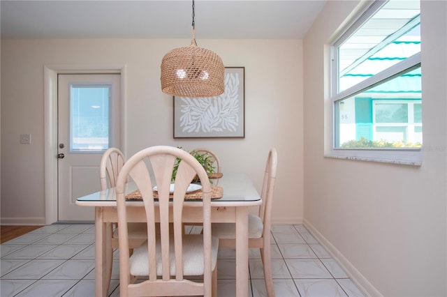 dining room with light tile patterned floors and baseboards