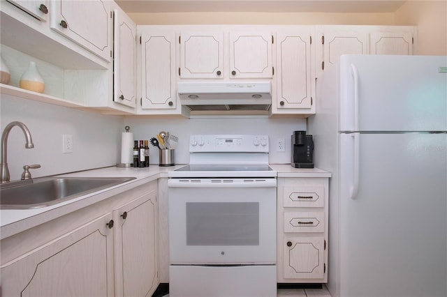 kitchen featuring white appliances, a sink, light countertops, white cabinets, and under cabinet range hood