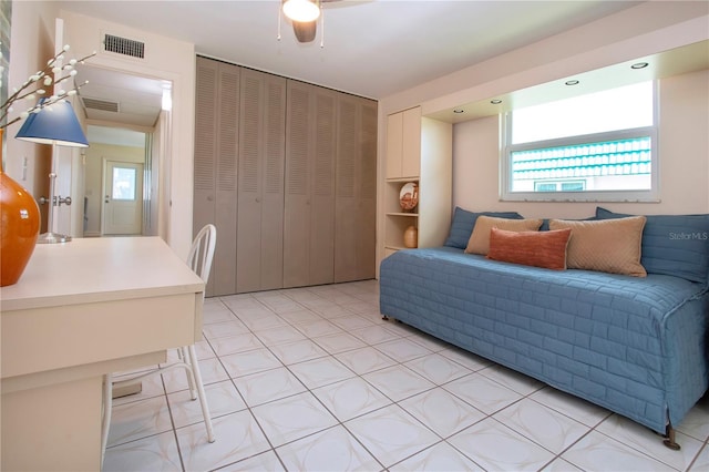 bedroom with visible vents, multiple windows, and a closet