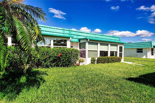 exterior space with stucco siding and a front lawn