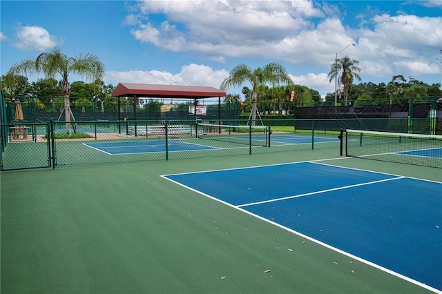 view of tennis court featuring fence