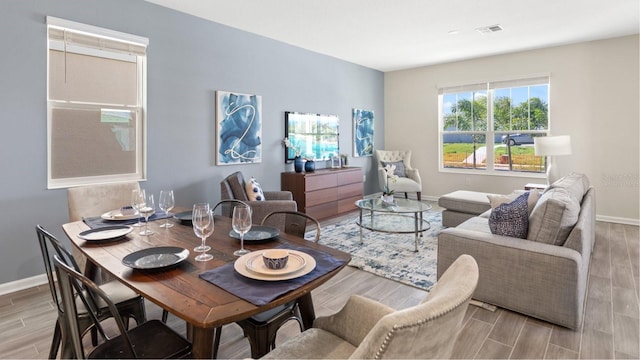 dining room with visible vents, baseboards, and wood tiled floor