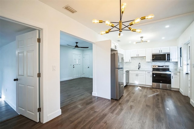 kitchen with visible vents, stainless steel appliances, white cabinets, decorative backsplash, and dark wood-style flooring