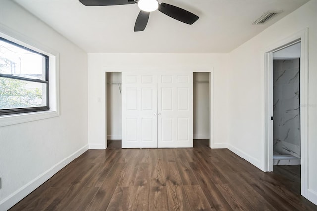 unfurnished bedroom with visible vents, dark wood-type flooring, baseboards, a closet, and a ceiling fan