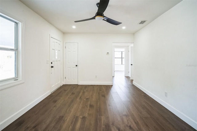 unfurnished room with visible vents, baseboards, ceiling fan, dark wood finished floors, and recessed lighting