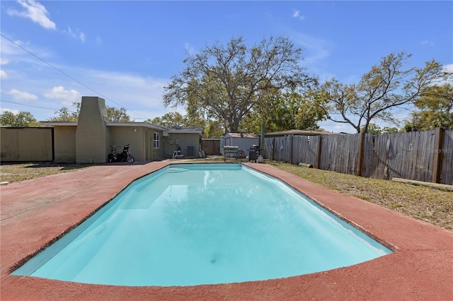 view of swimming pool with a fenced in pool, a patio, and a fenced backyard