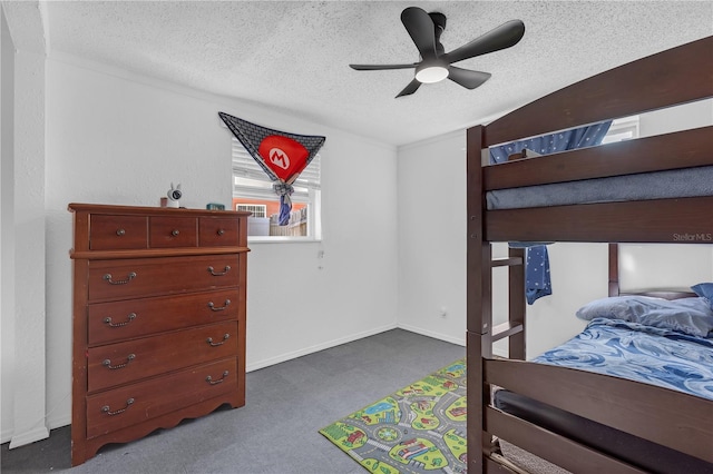 bedroom featuring ceiling fan, baseboards, dark carpet, and a textured ceiling