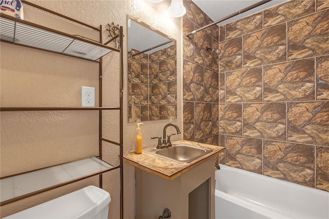 full bathroom with vanity, shower / bathing tub combination, and a textured wall