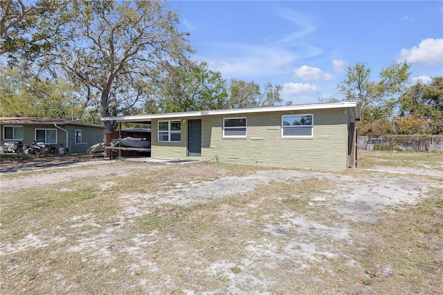 view of front of house featuring a carport and concrete block siding