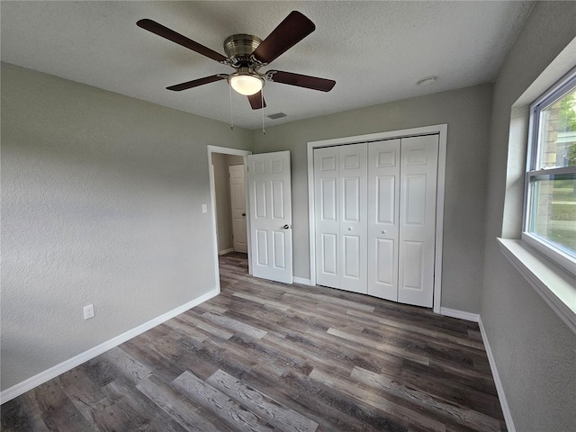 unfurnished bedroom with visible vents, wood finished floors, baseboards, and a textured ceiling