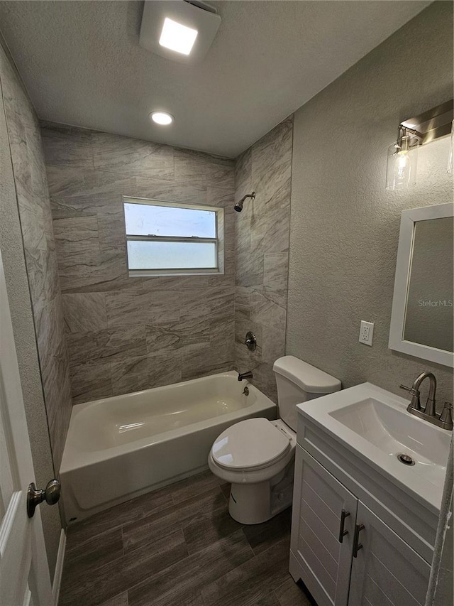 bathroom featuring toilet, wood finished floors, a textured wall, a textured ceiling, and  shower combination