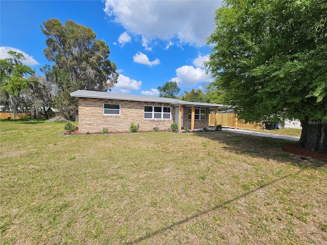 single story home with a front yard and fence