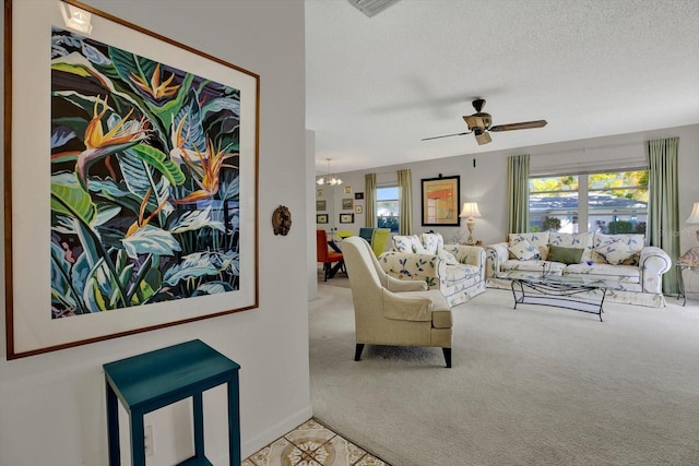 carpeted living room with ceiling fan with notable chandelier and a textured ceiling