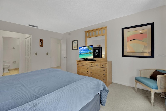 bedroom with visible vents, light carpet, a textured ceiling, and baseboards