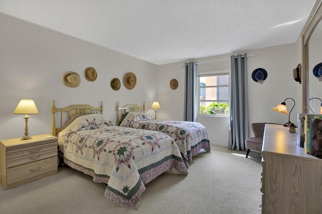 bedroom with carpet floors and a textured ceiling