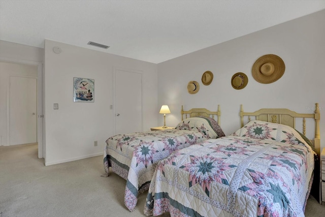 bedroom featuring visible vents, baseboards, and carpet