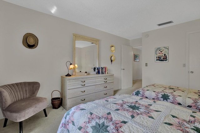 bedroom with light colored carpet and visible vents