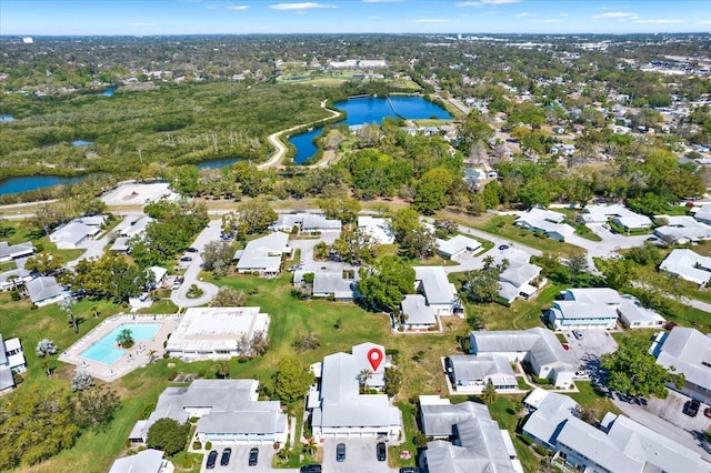 drone / aerial view featuring a residential view and a water view