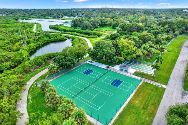 birds eye view of property with a wooded view and a water view