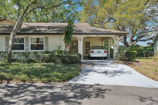 2009 Halidom Way, Sun City Center, FL 33573 - ranch-style home with an attached carport, brick siding, and driveway