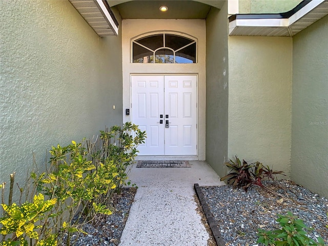 doorway to property with stucco siding